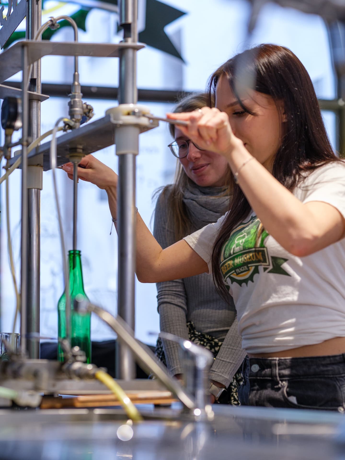 A visitor bottling her own beer at the Bottling Station filling line